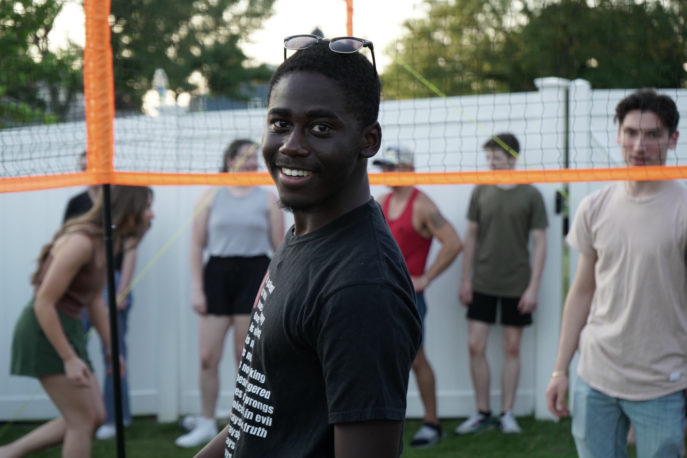 Young man in sunglasses near a volleyball net