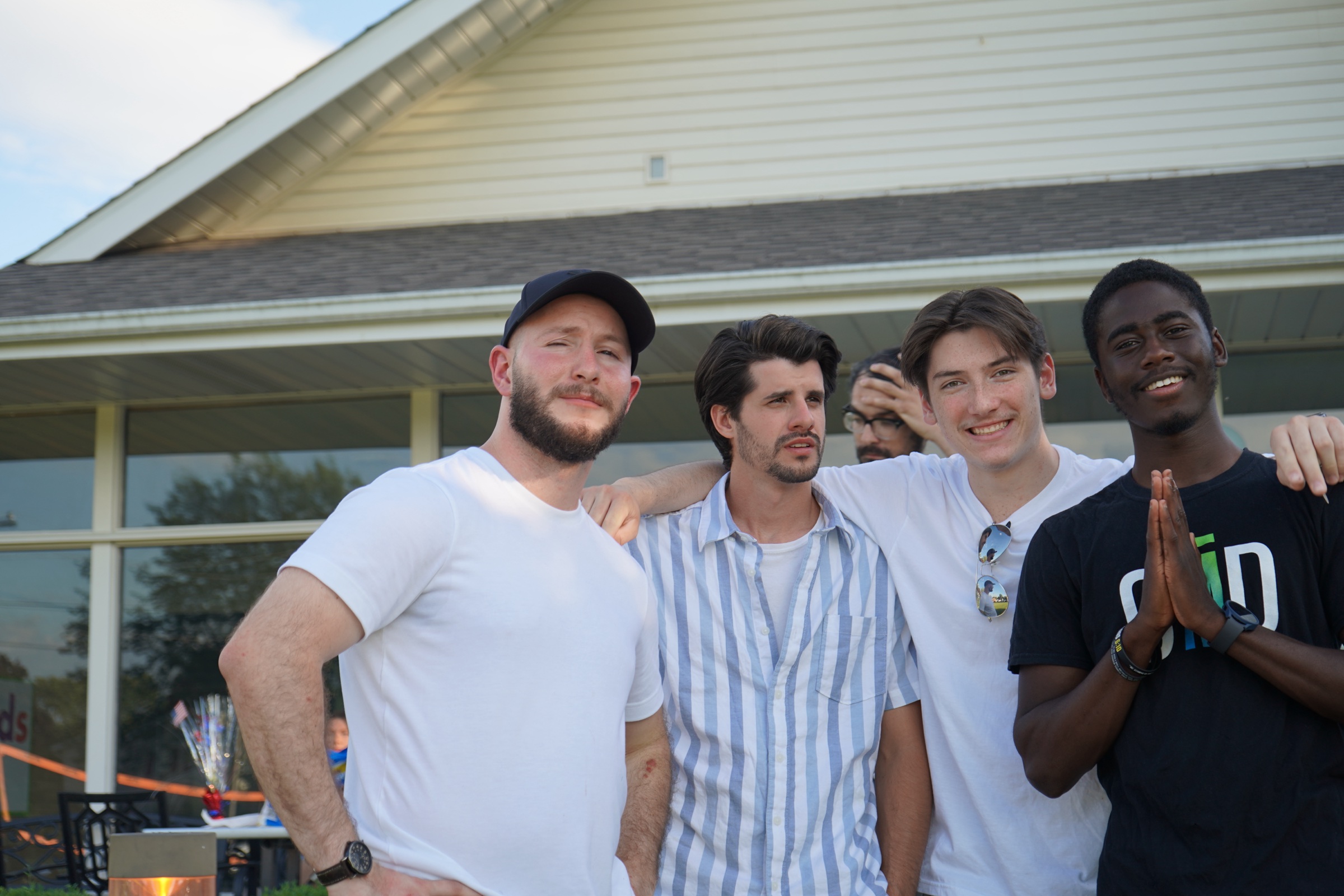 Four young men posing arm in arm at a CFC event