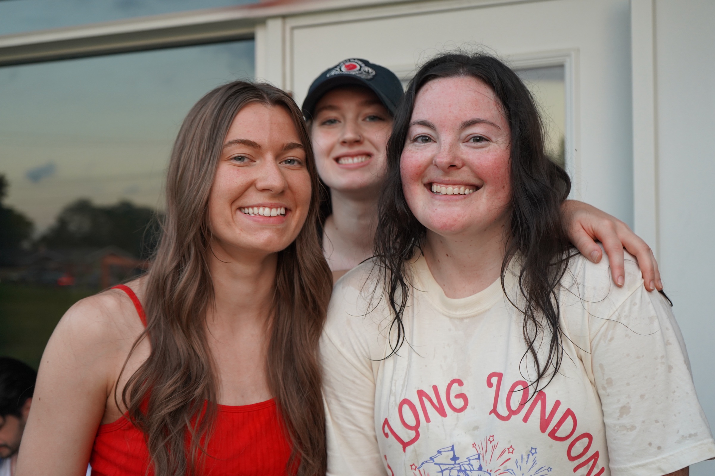 Three young women smiling outdoors at a CFC event
