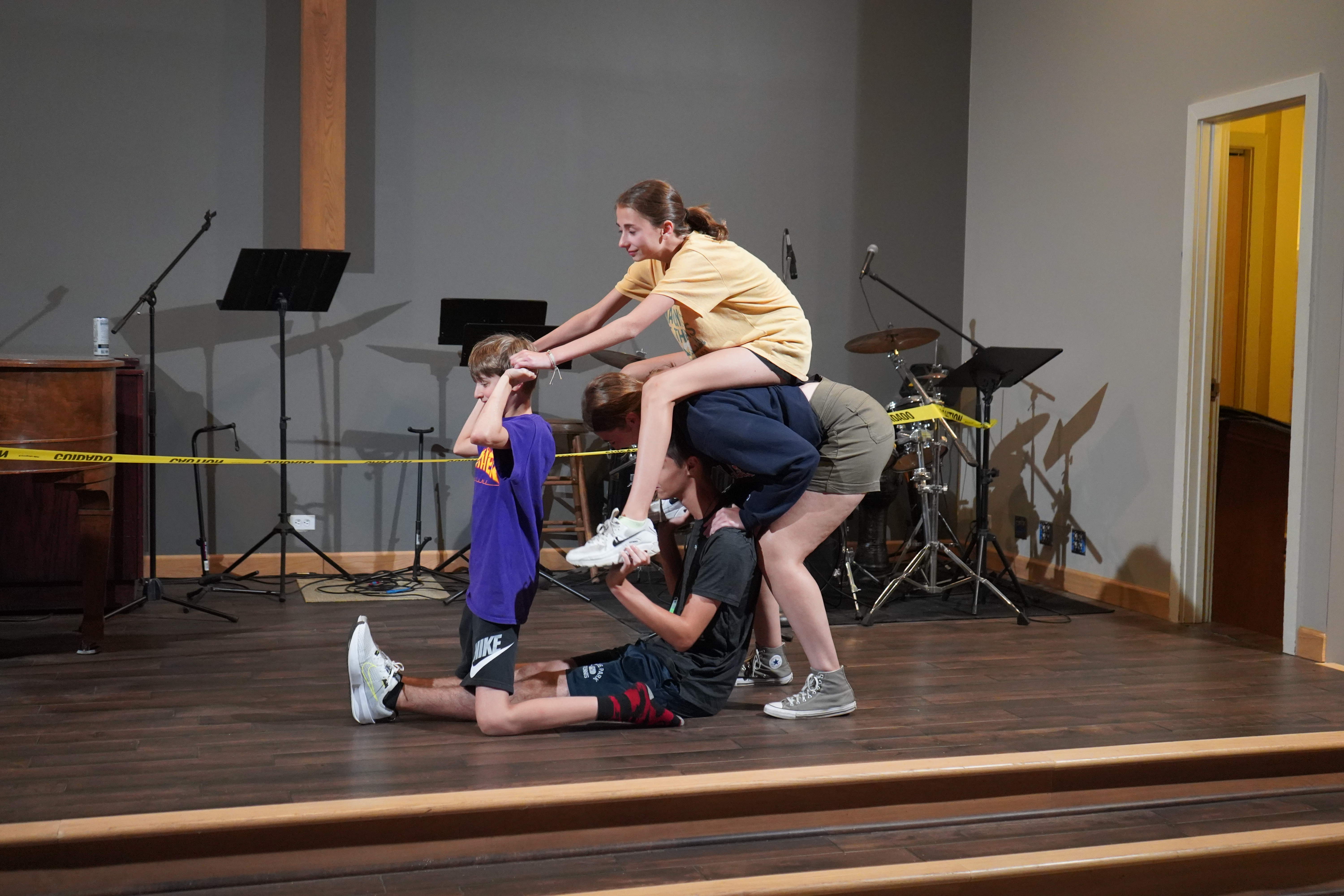 Youth group students doing a human bicycle skit