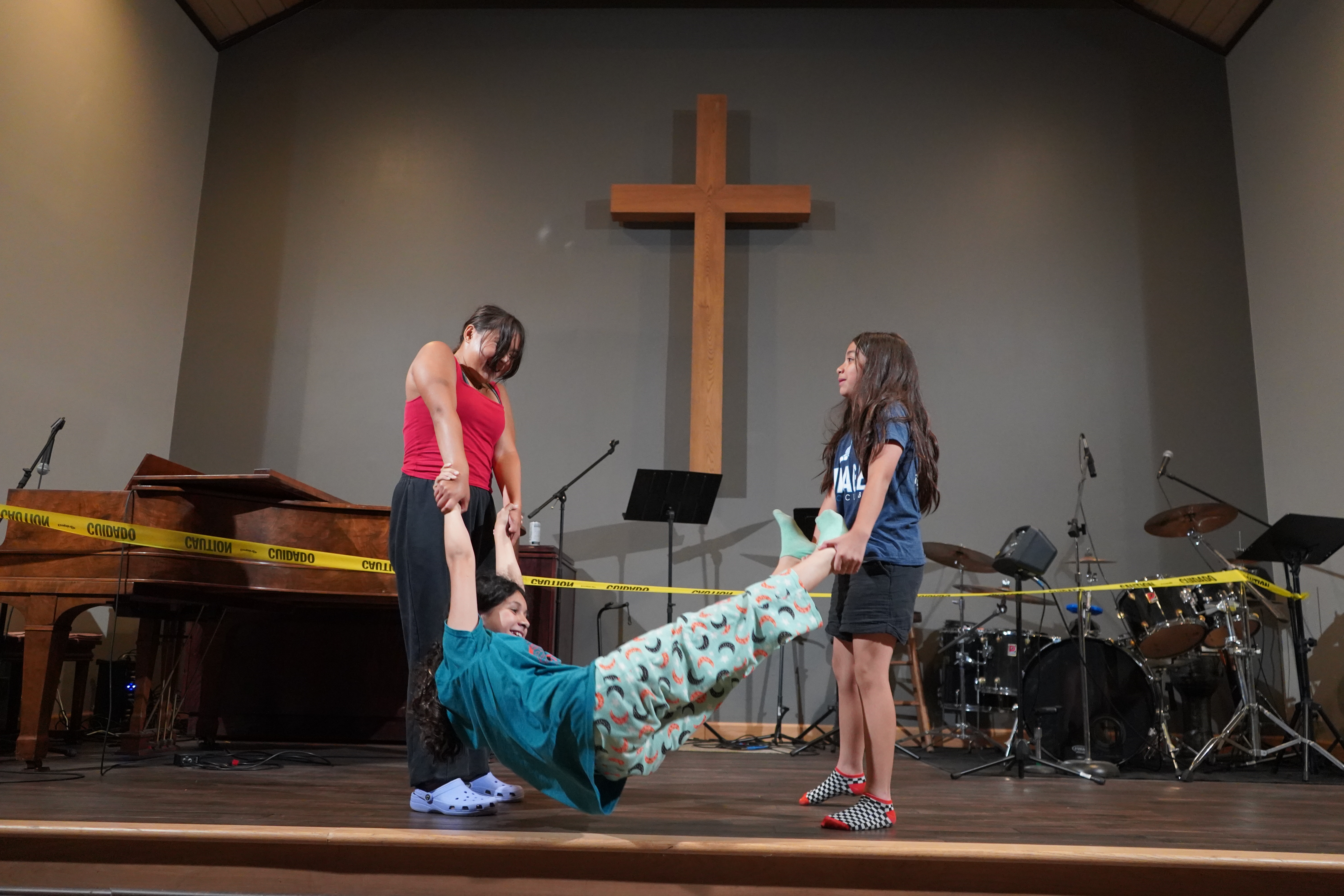 Youth group students performing a skit on stage